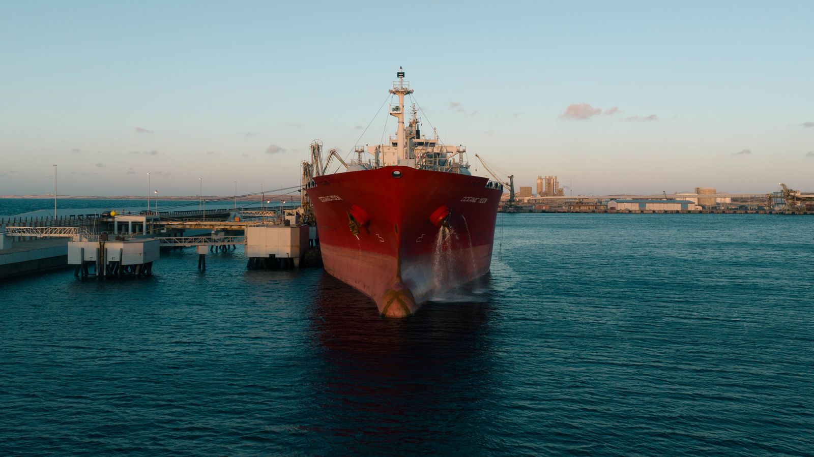 Commercial vessel alongside an industrial port